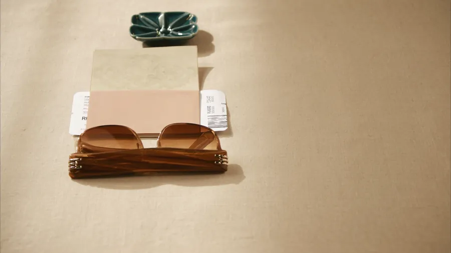 Passport, boarding pass and sunglasses laid out on linen before a medical trip