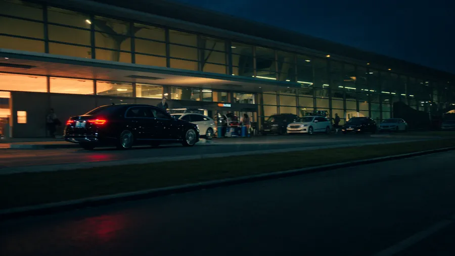 Black executive sedan waiting at the arrivals terminal of Istanbul Airport at night